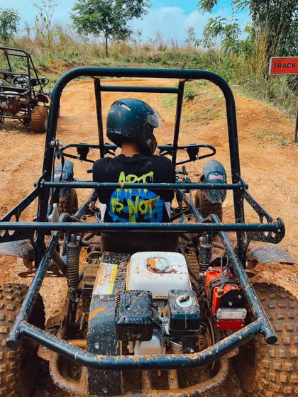 A view from the driver's seat of a dirt kart, ready to take on the challenging off-road track.