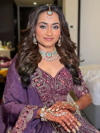 A closer view of the bride in her purple lehenga, highlighting the beautiful mint-green and diamond-look jewellery she paired with it.