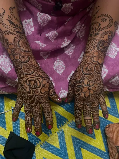 This engagement mehndi features the couple's initials hidden within the design. It's a beautiful way to personalize your henna for the special occasion.