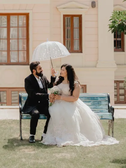 A sweet moment under an umbrella on a sunny day. This photo captures a classic, romantic movie vibe.