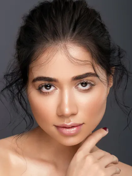 A slightly different angle from the same series, this portrait captures a direct and engaging gaze. The focus remains on the clean, glowing skin and the power of a simple, well-executed look.