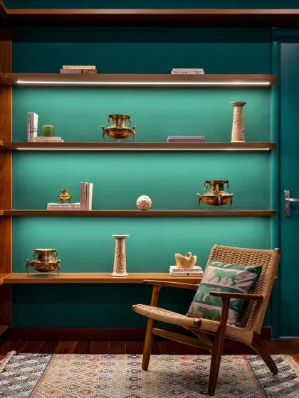 Another shot of the stunning emerald green curios unit in the 'Vasudhalayah' home office. The warm backlighting creates a dramatic and elegant focal point in the room.