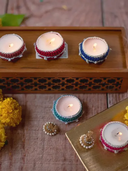 Our small crochet diya jackets are perfect for scattering light around your home. Available in a range of colors like red, blue, green, and pink, they fit standard tea lights and can be reused year after year.