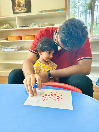 A father and his little girl share a tender moment during a creative activity. Our program is designed for both moms and dads to participate, strengthening family bonds through shared experiences.