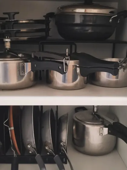 Vertical storage is key for bulky items. Here, we've used pan and lid organizers to store pressure cookers and pans upright, preventing scratches and making them easy to grab.