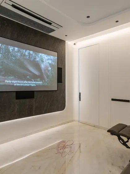 Movie night in session. This image captures the immersive experience of watching a film on the large projection screen, with the room's lighting dimmed to create a perfect theater ambiance.