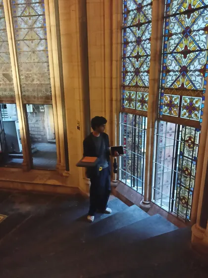 A photo of me sketching inside a beautiful old building. I find inspiration everywhere, from grand architecture to small details.