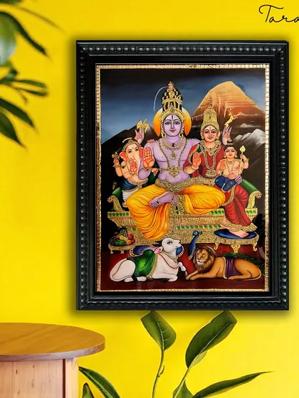 Our Shiva Family Tanjore painting, depicted against a vibrant yellow wall, shows how traditional art can create a striking and spiritual focal point in a contemporary home setting.