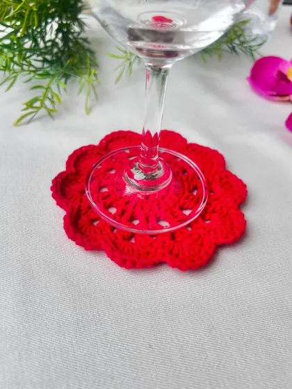This vibrant red mandala coaster is designed to perfectly cradle the base of a wine glass. It's a simple way to add a touch of elegance and protect your furniture during a relaxing evening.