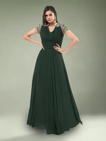 This simple yet elegant dark green gown features beautiful embellished sleeves. It's a sophisticated choice for a formal dinner or event.