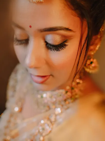A delicate close-up of the bride, focusing on her soft makeup and elegant features.