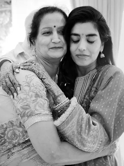 A touching black and white portrait of the bride embracing her mother, a moment filled with unspoken emotion and love.