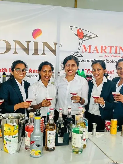 A group of female hospitality students proudly display the mocktails they created during our collaborative workshop with Monin.
