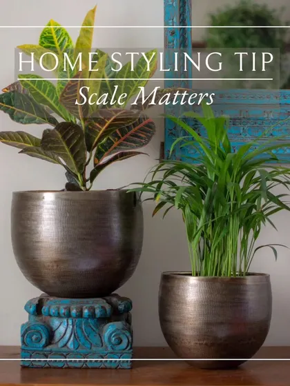 When styling, consider the relationship between your planters. Placing a taller planter on a pedestal next to a shorter one adds height and dimension to your display.