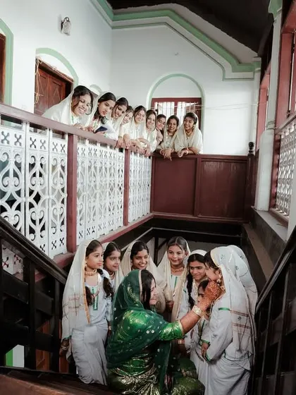 A candid moment from inside a traditional Kerala house during an Arikuth ceremony, with family members looking on with love.