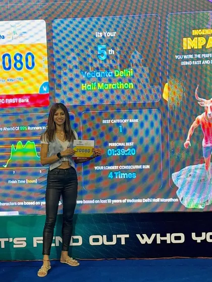 At the Vedanta Delhi Half Marathon expo, seeing my stats on the big screen. A personal best and a number one category rank from a previous year, fueling the fire for the next race.
