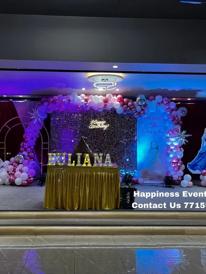 Another perspective of the princess party stage, showing the arrangement of the cake table with the child's name in marquee letters.