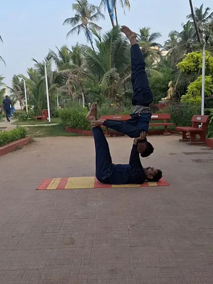Another angle of our partner acro-yoga practice. The flyer balances perfectly on the base's feet, demonstrating advanced balance and coordination developed through our training.