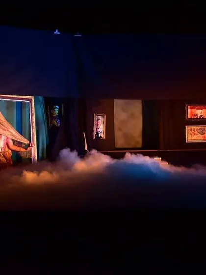 We use special effects like theatrical fog to create an ethereal and dramatic atmosphere. This scene shows a veiled puppet, adding a layer of mystery and beauty to the production.