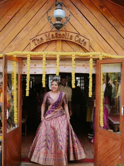 The bride, radiant in her purple lehenga, makes a grand entrance at her Mehendi ceremony held at 'The Magnolia Cafe'.