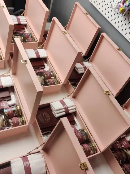 Assembling the luxury hampers for the Shaswat store launch. Each item is carefully placed to ensure a beautiful unboxing experience for the recipient.