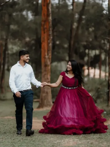 This couple's pre-wedding shoot captures a walk through the woods. Our magenta gown flows beautifully with every step.