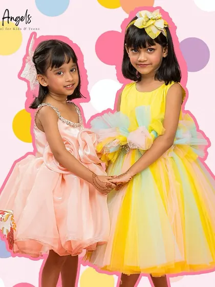 Two friends, one in our peach "Flower Dress" and the other in the yellow "Pretty Ivy" dress.