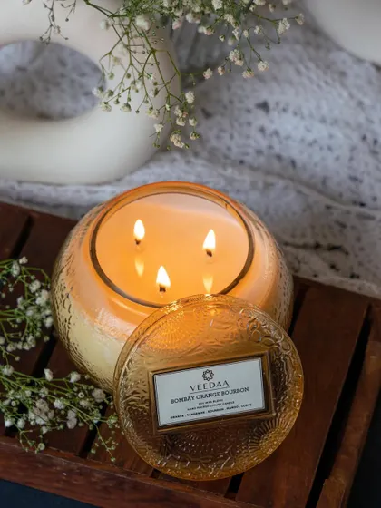 The warm, inviting glow of our four-wick Bombay Orange Bourbon candle. This large, hand-cut glass candle is perfect for making a statement and filling your space with its rich, citrusy aroma.