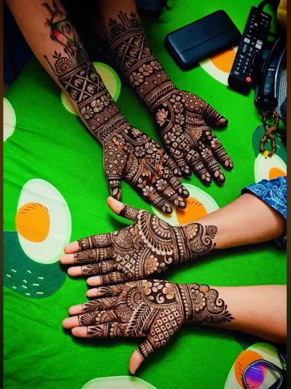 A group photo showing mehandi for multiple people, perfect for a bridal party or family celebration.