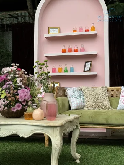 A lounge nook with a pink wall featuring shelves of colorful potions, adding to the "Tale of Two Souls" magical theme.