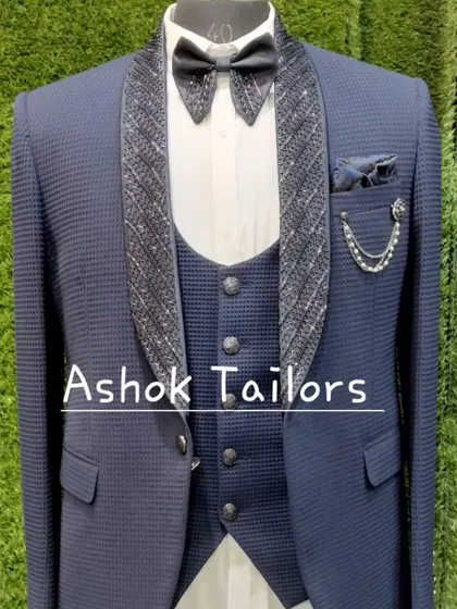 A blue suit with a textured fabric and a sparkling lapel. This is a ready-to-wear party outfit.