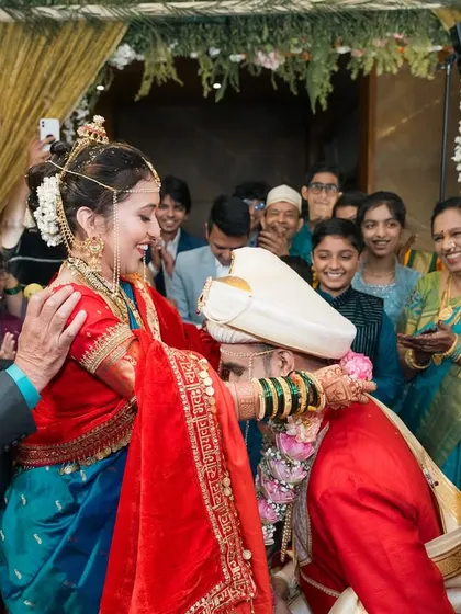 A moment of blessing and respect during a Maharashtrian wedding ceremony.