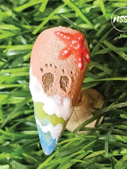 A day at the beach, right on your nails. This design features a sandy texture, footprints, a starfish, and ocean waves, all in one creative piece.