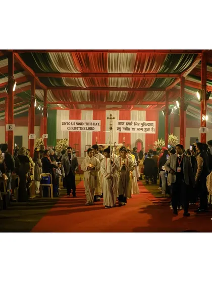 A Christmas mass procession walks down a red carpet inside a large tent, decorated in festive colors.