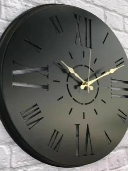 A solid, bold design, this wooden analogue clock features cutout Roman numerals against a solid black face. The antique finish and classic styling make it a substantial and stylish piece for any wall.
