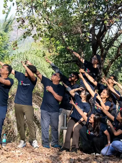 Our community of seekers pointing towards the sky, sharing a moment of collective joy and wonder during a nature walk.