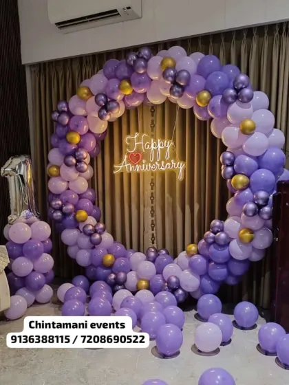 Our anniversary ring combines purple, lilac and metallic balloons with a glowing anniversary sign against a curtain backdrop.