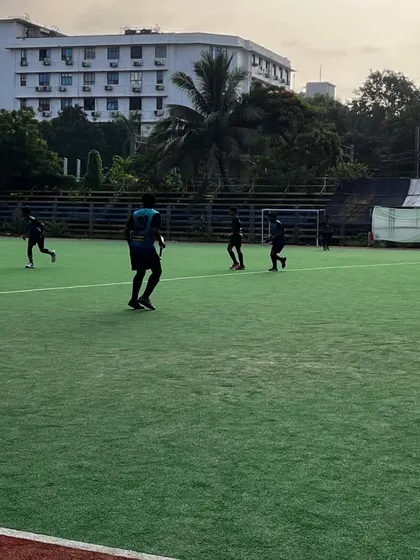 Our players spread out across the turf, maintaining their formation during a competitive game. Positional discipline is a key aspect of our training and success.
