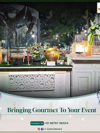 A beautiful white buffet station set against a waterfall backdrop, showcasing how we bring a gourmet experience to any event space.