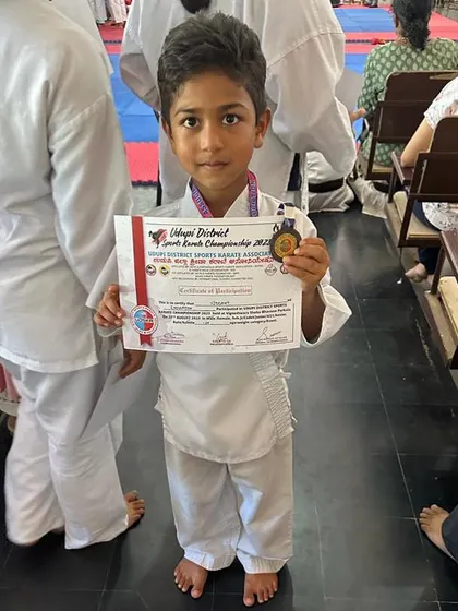 This young karateka is thrilled with his medal win at the Udupi District Sports Karate Championship.
