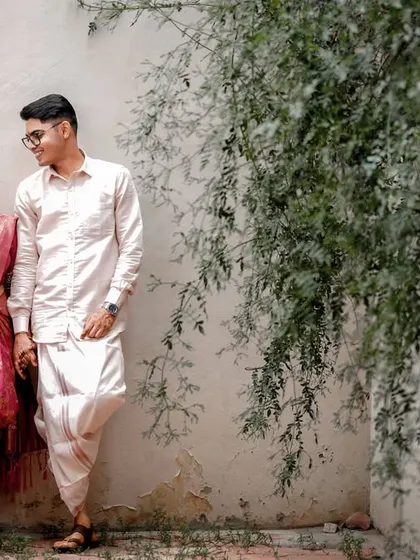 A classic portrait of the couple standing together, showcasing their traditional wedding attire.