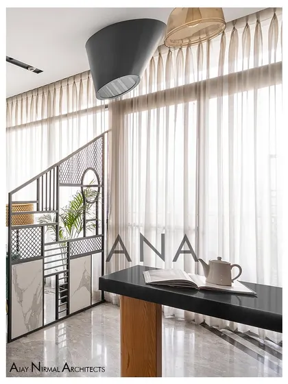 A detail of the custom metal partition and bar table in Apartment 704. This element acts as a visual separator while maintaining the open feel of the living area.