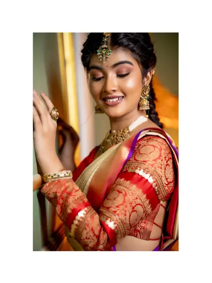 A close-up of the beautiful Amrutha Prem, styled for Day 2 of 'Navataara'. The focus is on her radiant smile and the intricate brocade blouse.