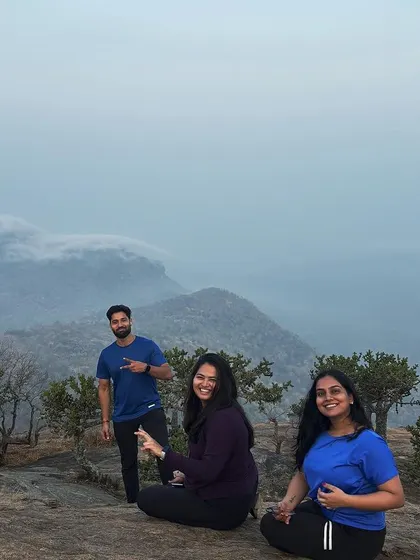 Three colleagues enjoying the misty mountain view. Our treks provide a space for informal, relaxed interactions that build stronger working relationships.