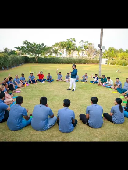 Leading an icebreaker session in a circle. This format is great for helping team members learn about each other in a relaxed, informal outdoor setting.