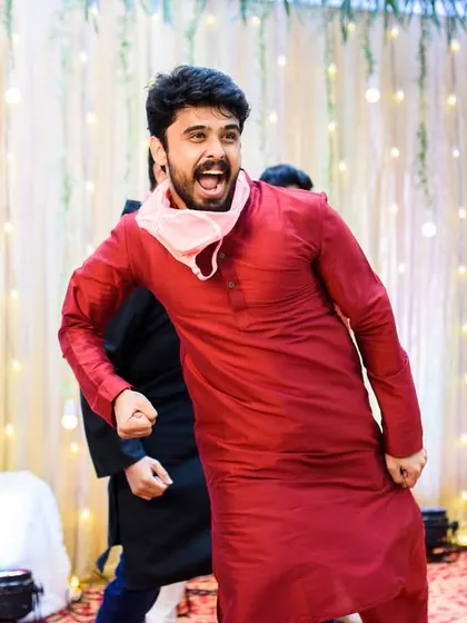 The groom's friends brought an incredible amount of energy to the sangeet performance. This shot captures the peak of their madness.