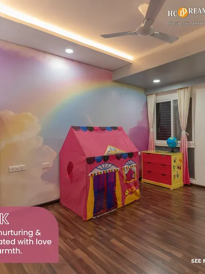 The same whimsical kid's room, showcasing how the pink color scheme creates a calm and loving environment. The open bookshelf encourages a love for reading from a young age.