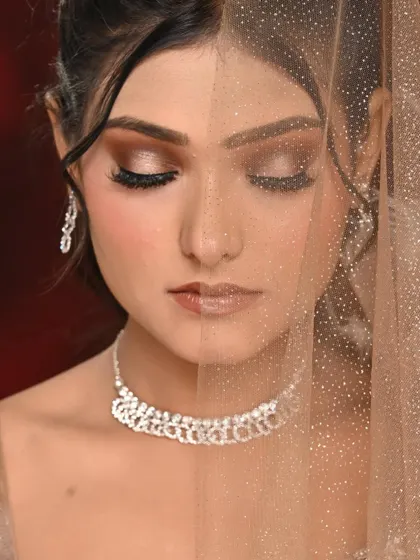 A creative shot showing the spotlight eye makeup through a shimmery veil. The effect is dreamy and ethereal.
