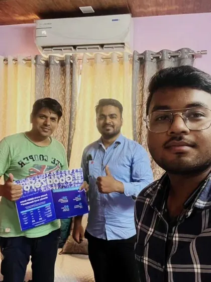 Our team takes a selfie with two customers holding our "GoodZero" brochure.