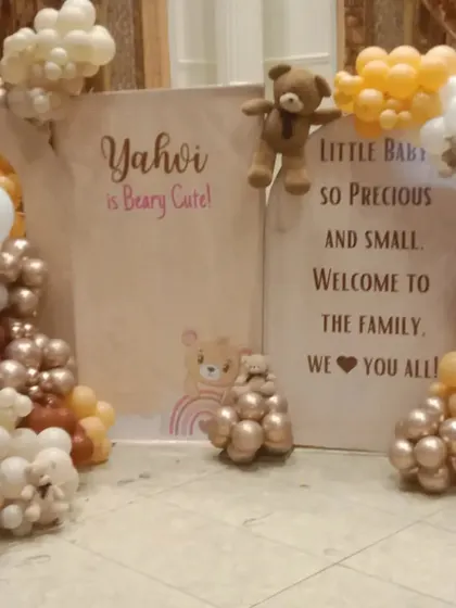 A welcome baby decoration with a "Yahvi is Beary Cute" theme. The setup uses a warm, neutral color palette of brown, beige, and orange balloons to create a cozy and inviting atmosphere.